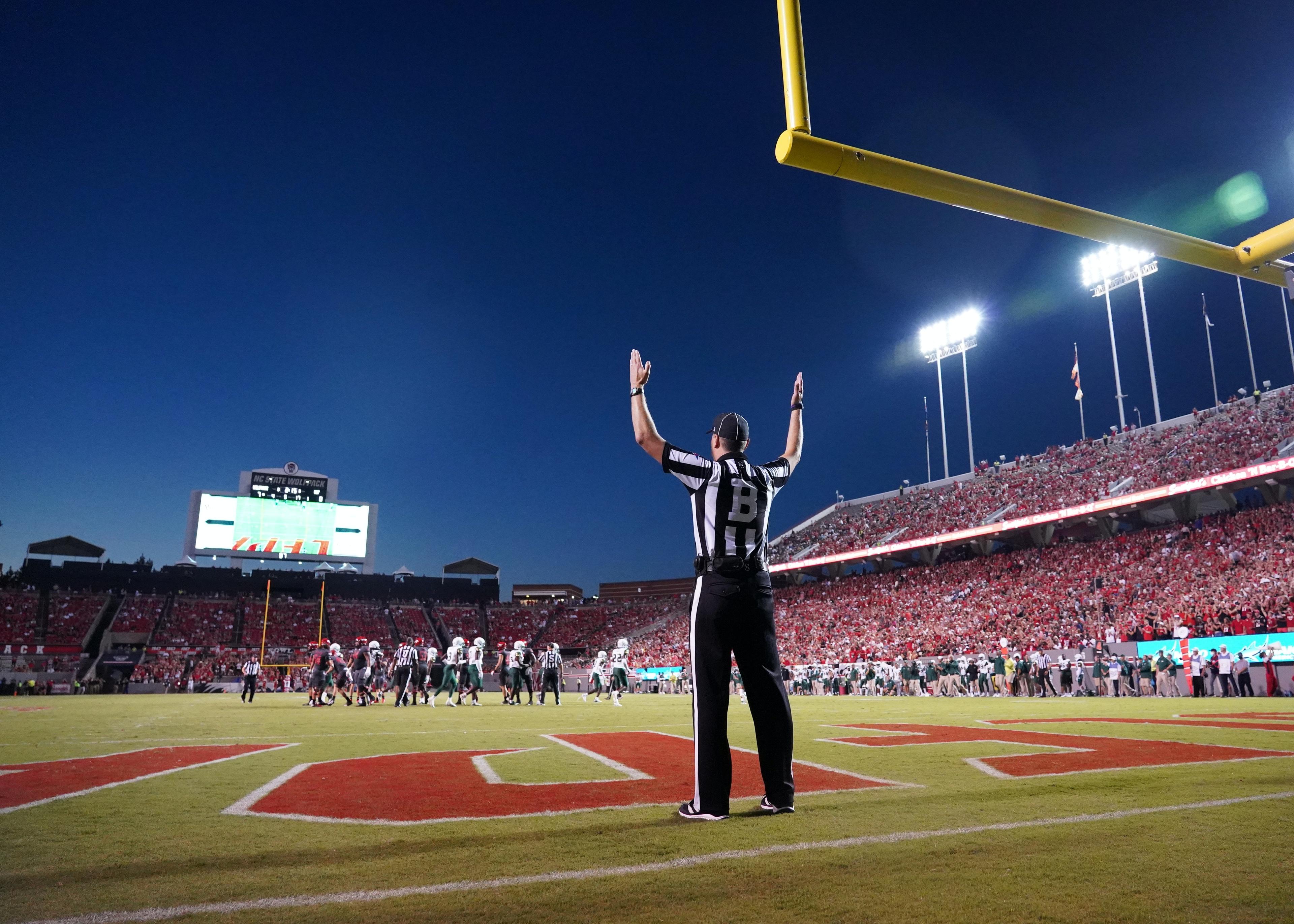 Football referee signaling touchdown