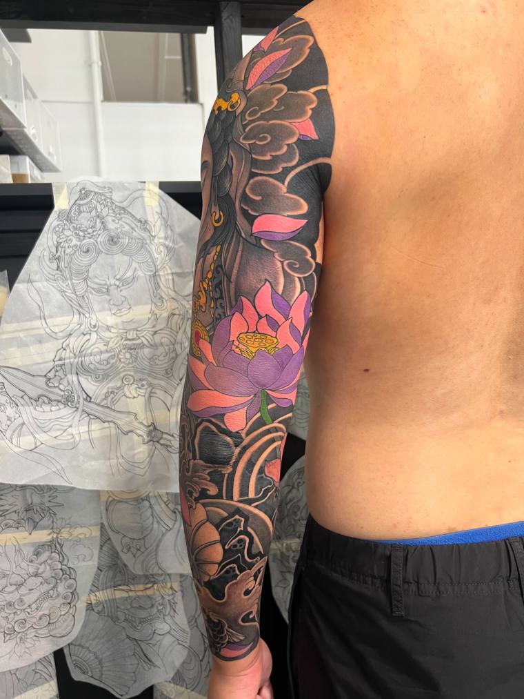 An oriental arm sleeve featuring a vibrant lotus flower.
