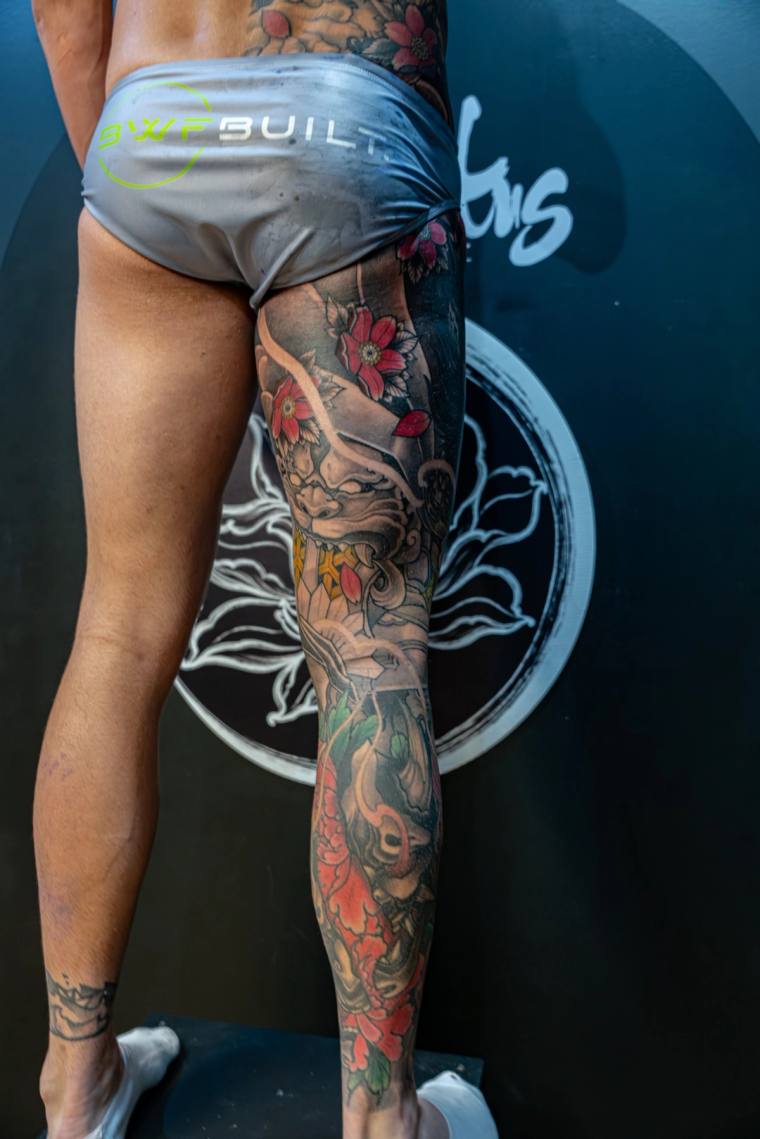 Finished Japanese irezumi full leg sleeve featuring a hannya mask, red peonies, and cherry blossoms on a client's right leg.