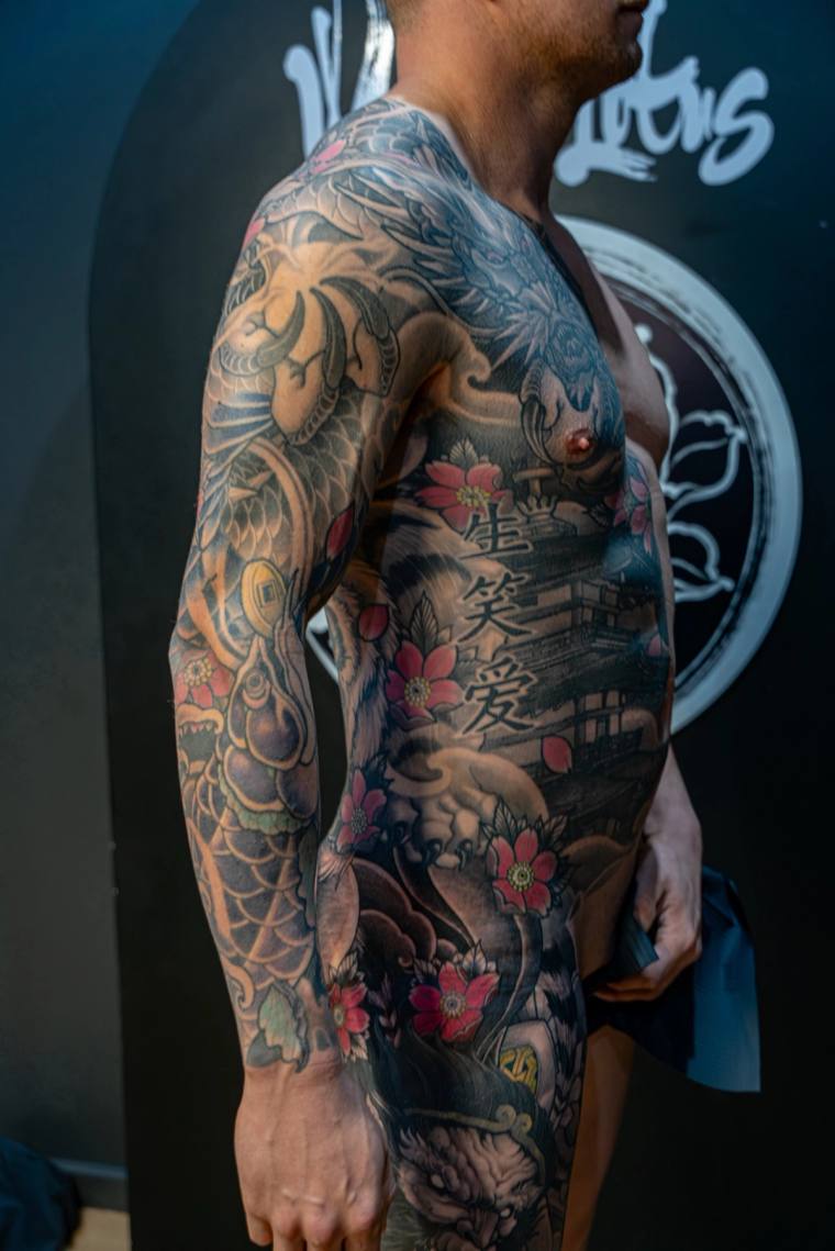 Healed irezumi full sleeve and side piece featuring a dragon, koi, cherry blossoms, hannya mask, and a Japanese pagoda scene 