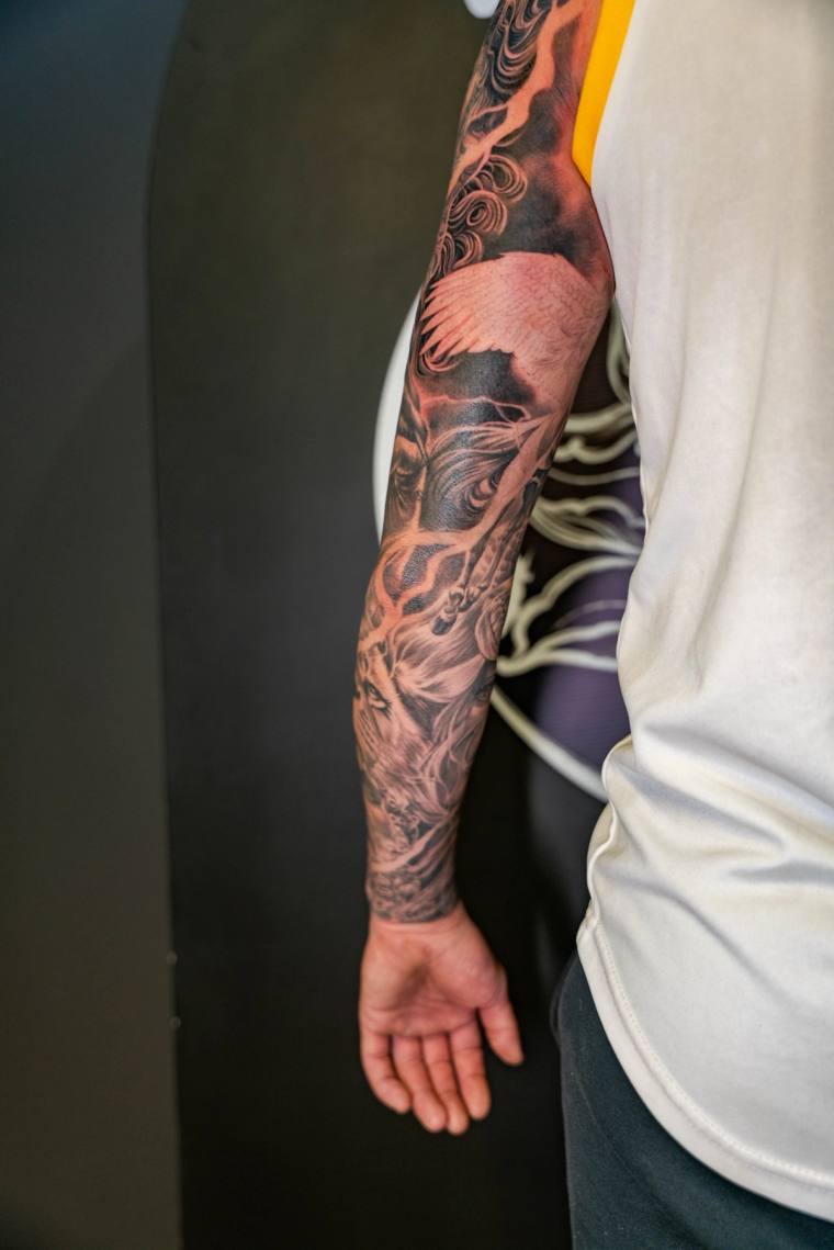 Full black and grey irezumi sleeve featuring a crane with flowing feathers and traditional Japanese wind bars and clouds.