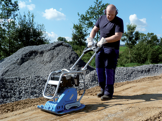 man using a compactor