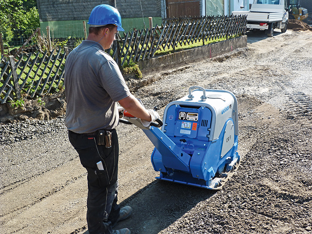 man using a compactor