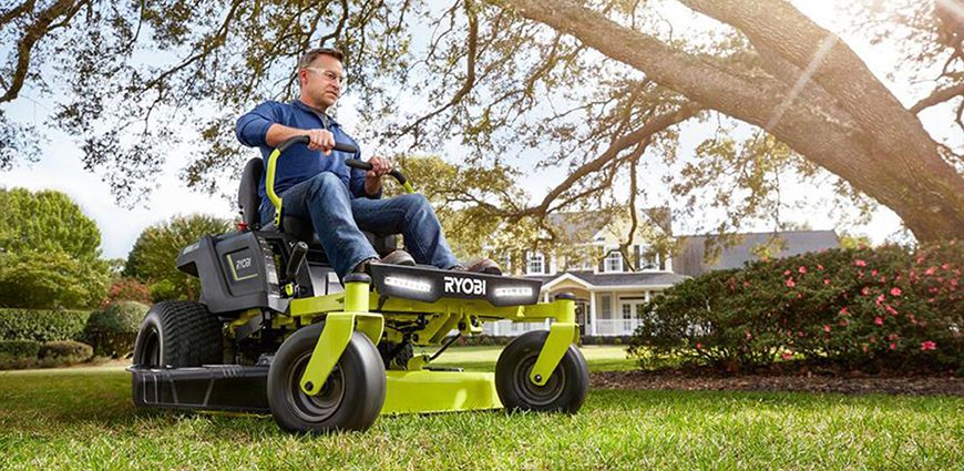 man riding Ryobi Mower