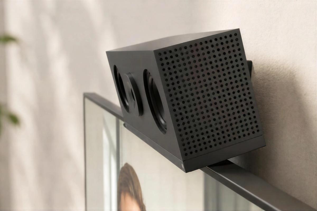 Compact camera on a Heckler mount resting on top of a display, angled toward the room.