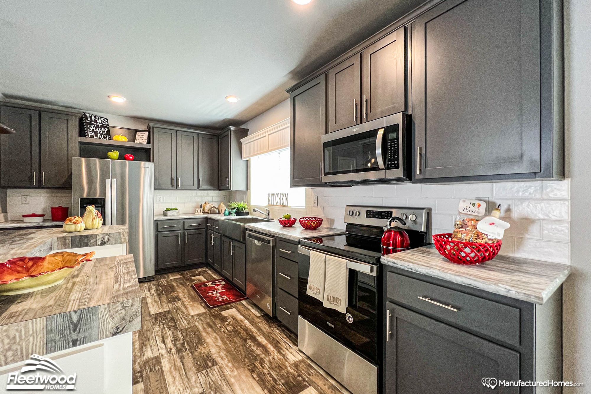 Large kitchen with wood-look countertops.