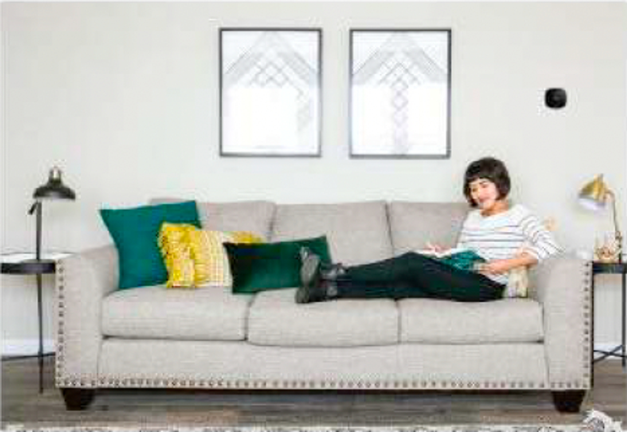 Woman sitting on couch reading a book.