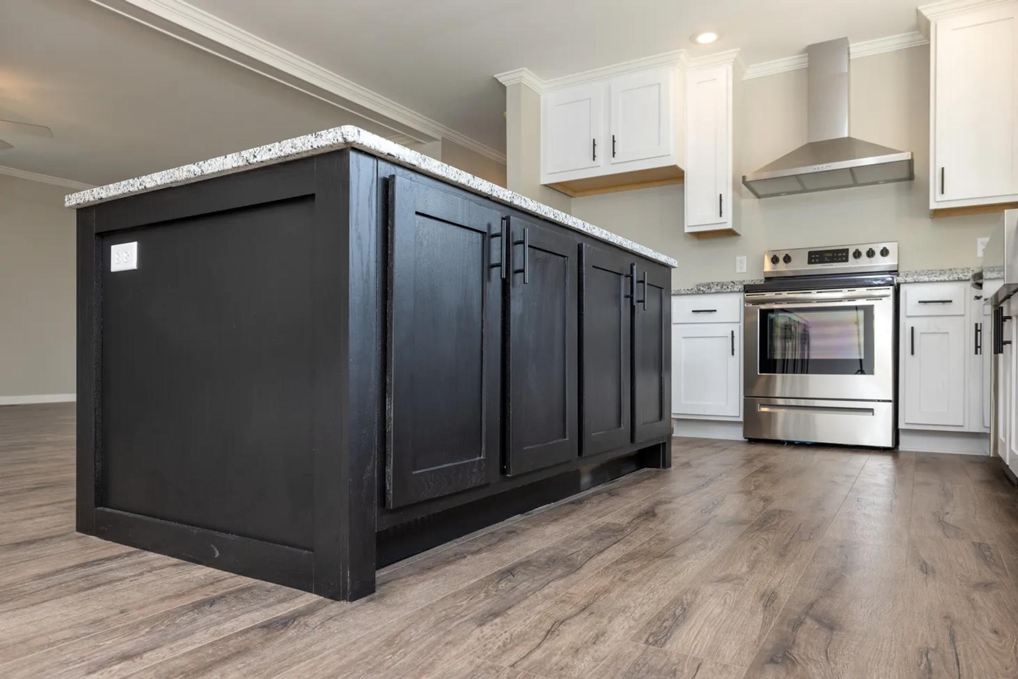 Low view of kitchen displaying black cabinets on the island.