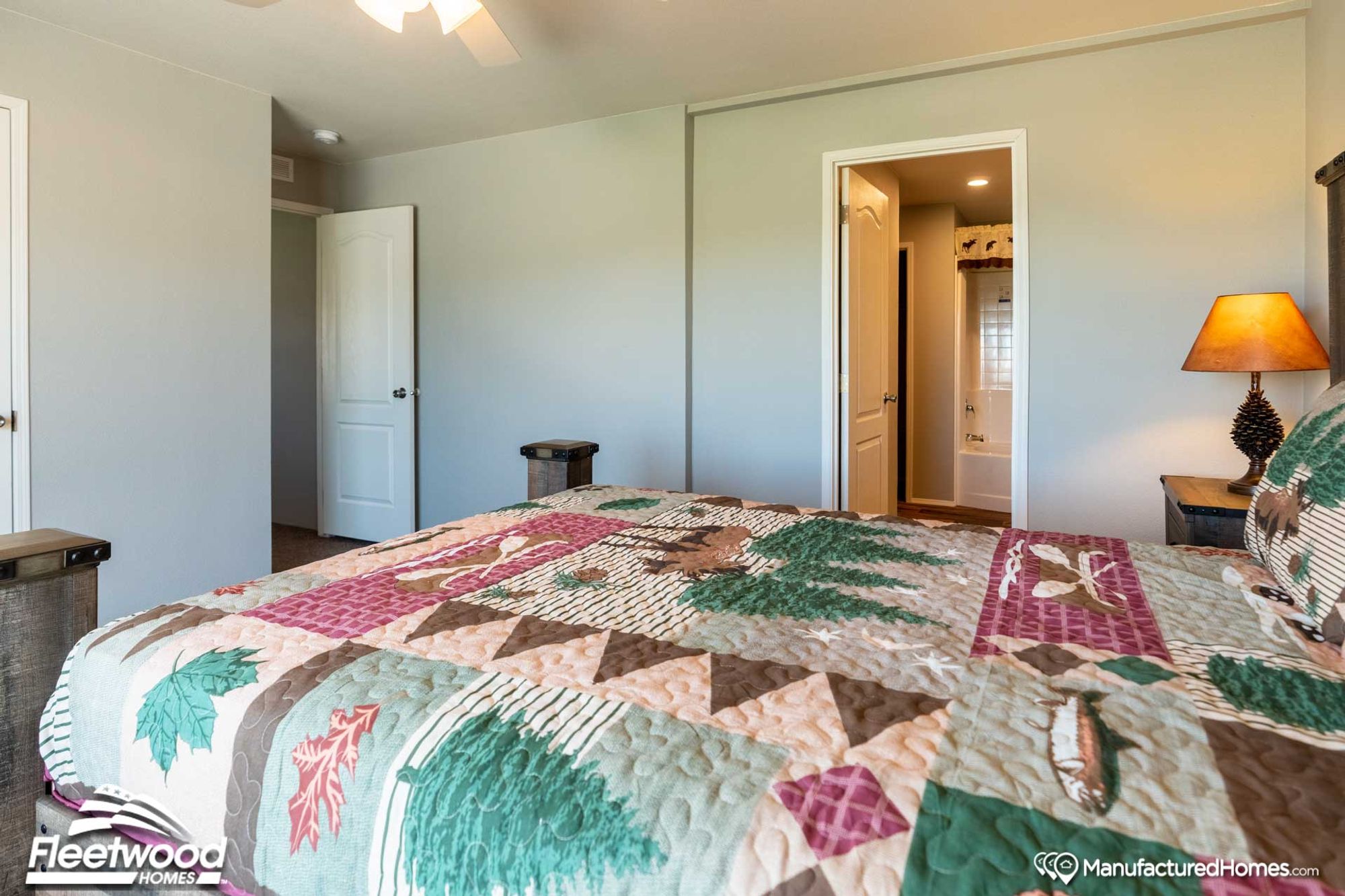 Mid-sized bedroom with a full bed and a side table.