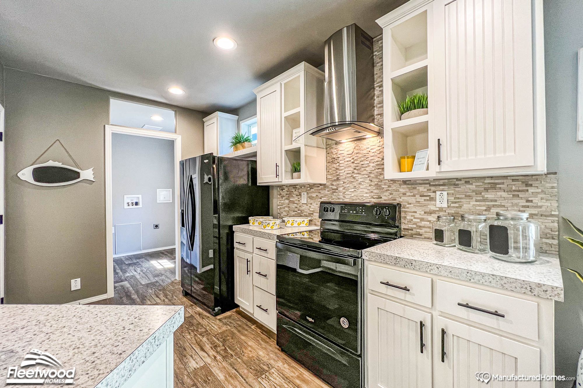 Close-up of a large kitchen showing an oven and a fridge.
