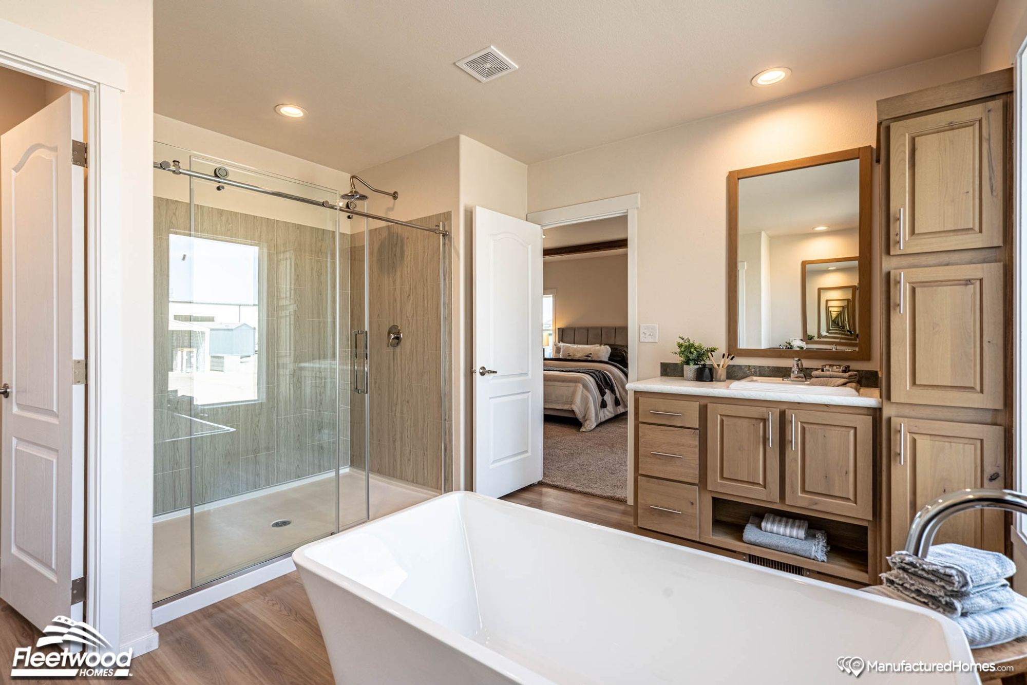 Large bathroom with a bathtub and a large standing shower.