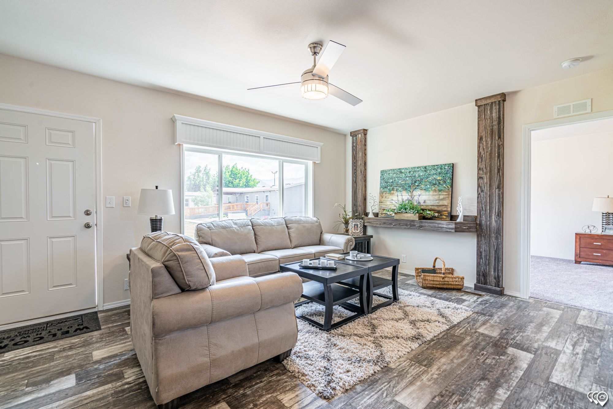 Front room with a large couch, a chair, a coffee table, and two side tables.