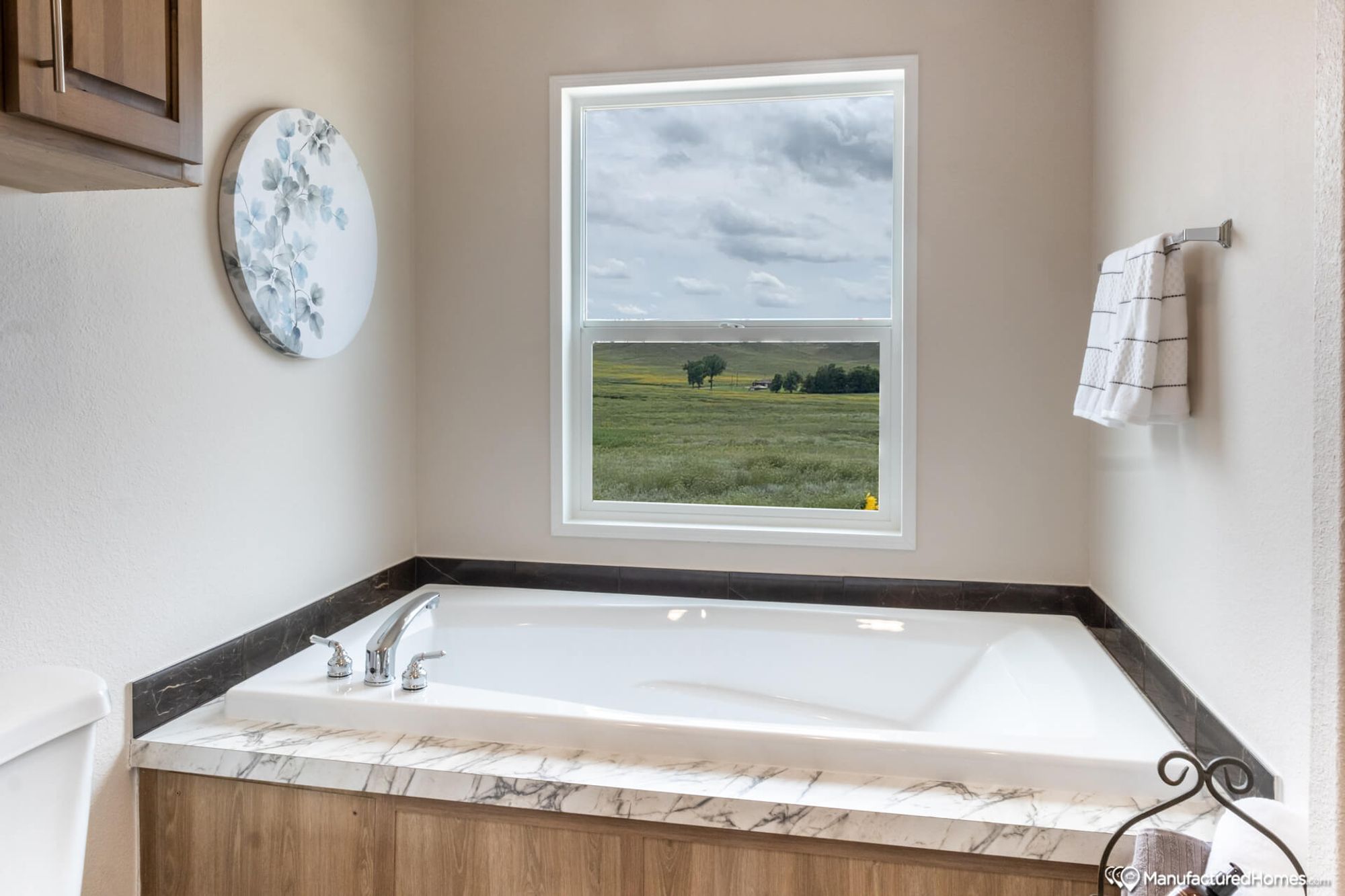 Close-up of a bathroom with a large bathtub.