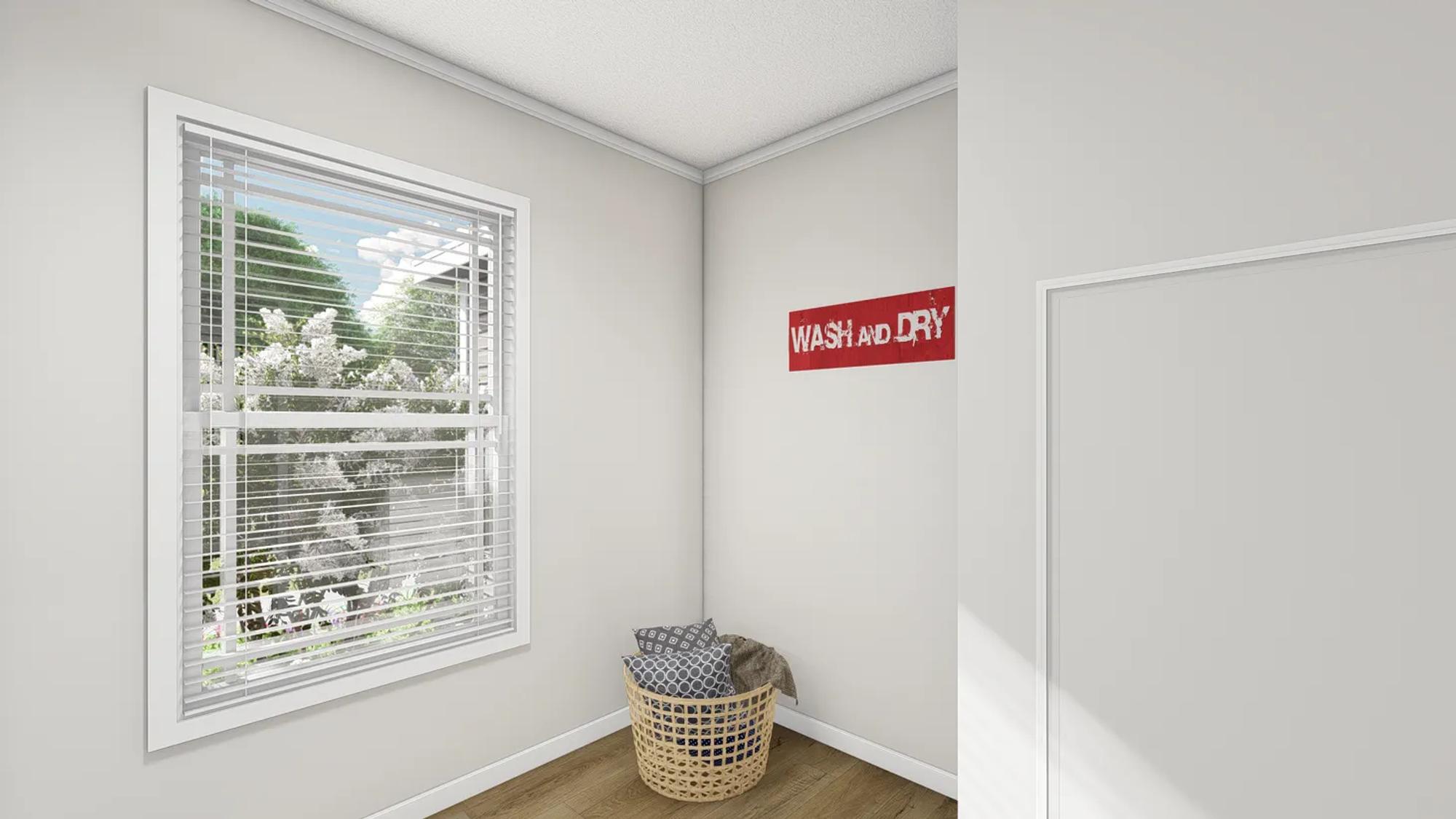 White room with a hamper with pillows and a 'wash and dry' sign