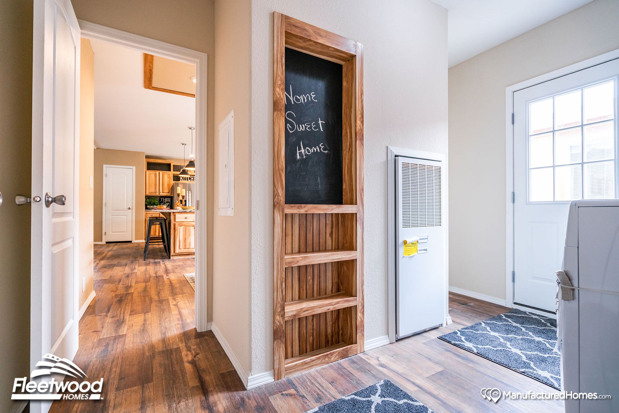 Walkway with a door to the outside and built-in wooden wall shelving.
