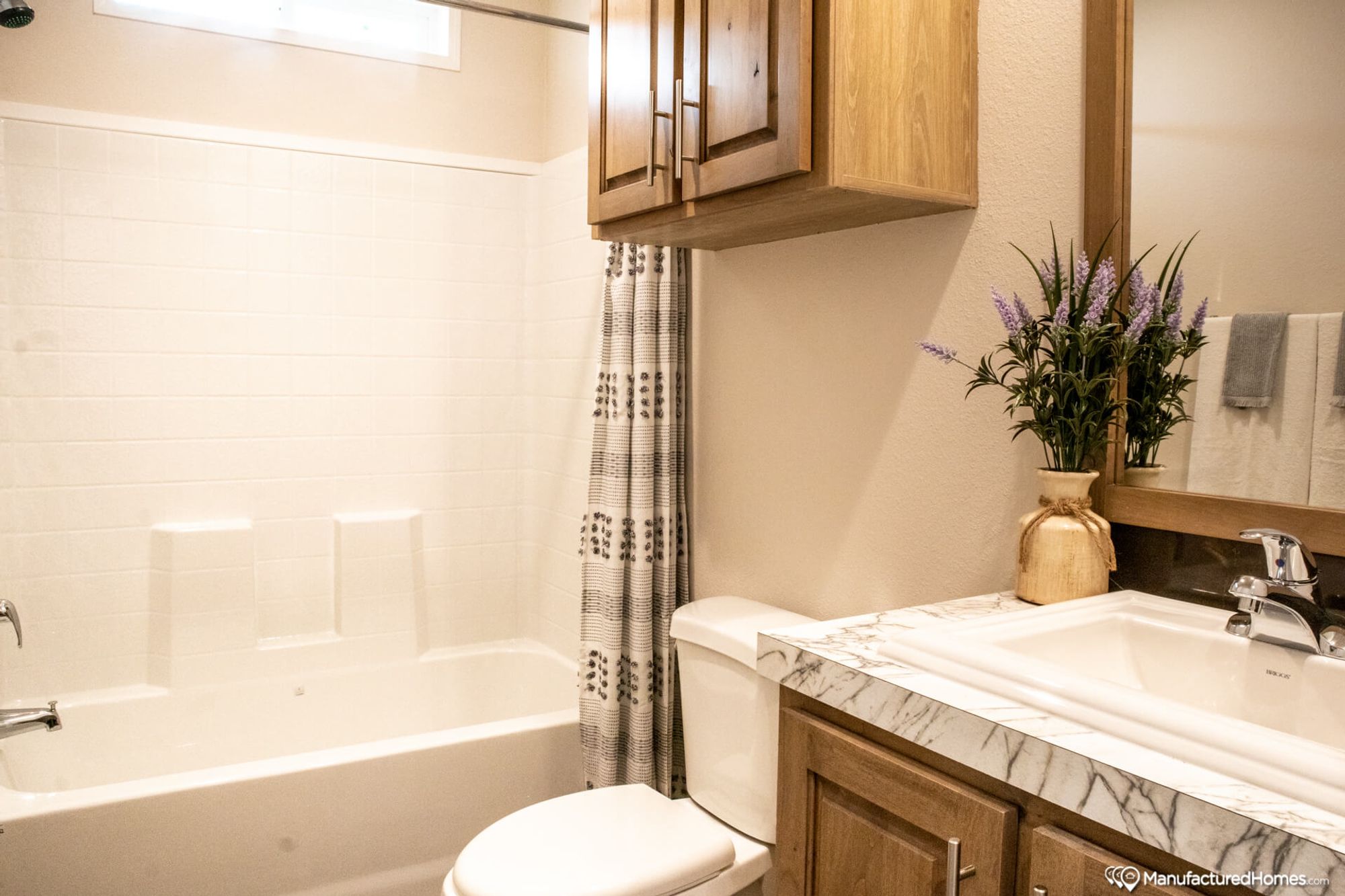 Small bathroom with a shower-bathtub combo and a single sink.