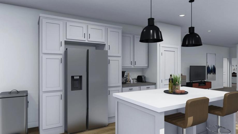 Medium-sized kitchen with white cabinetry, silver appliances, and an island.
