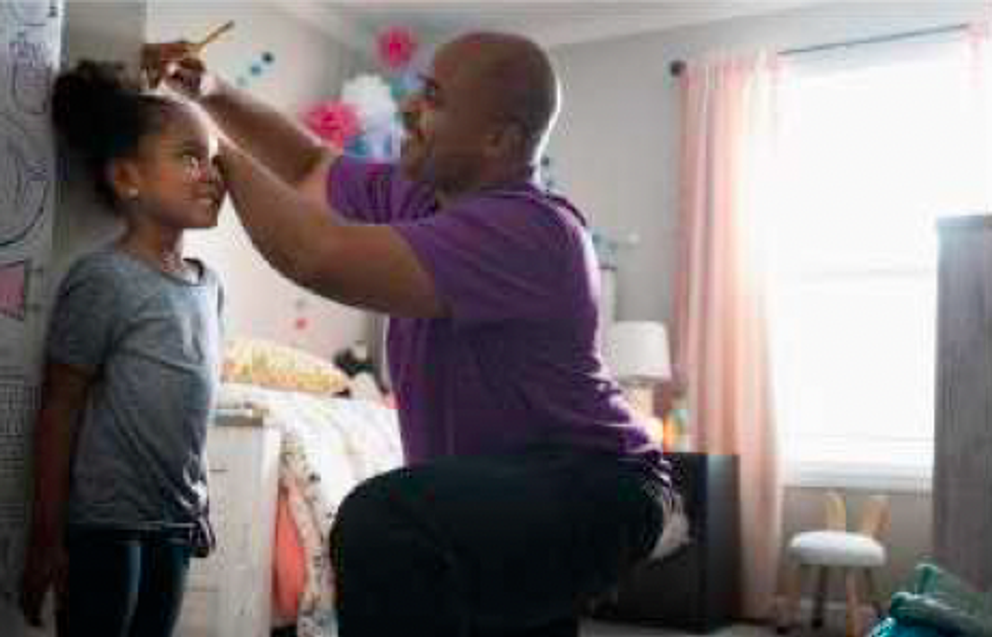 Father measuring daughter&apos;s height