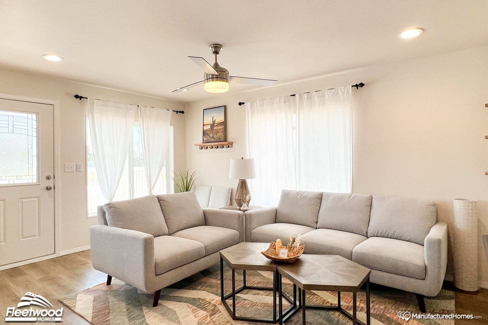 Mid-sized living room with two couches, a coffee table, a side table, and two chairs in the background.