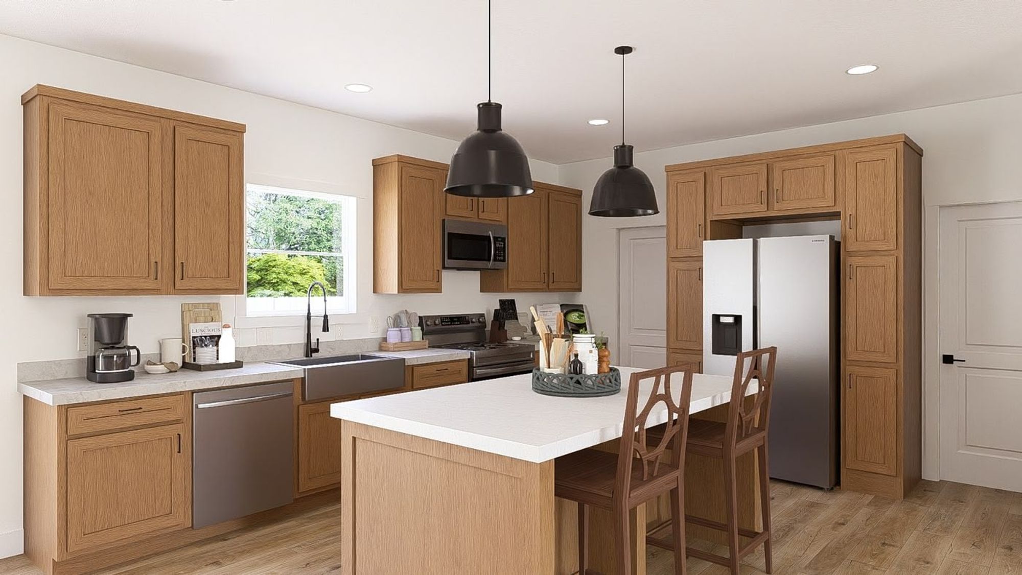 Large kitchen with an island, white countertops, a farmhouse-style sink, and silver appliances.
