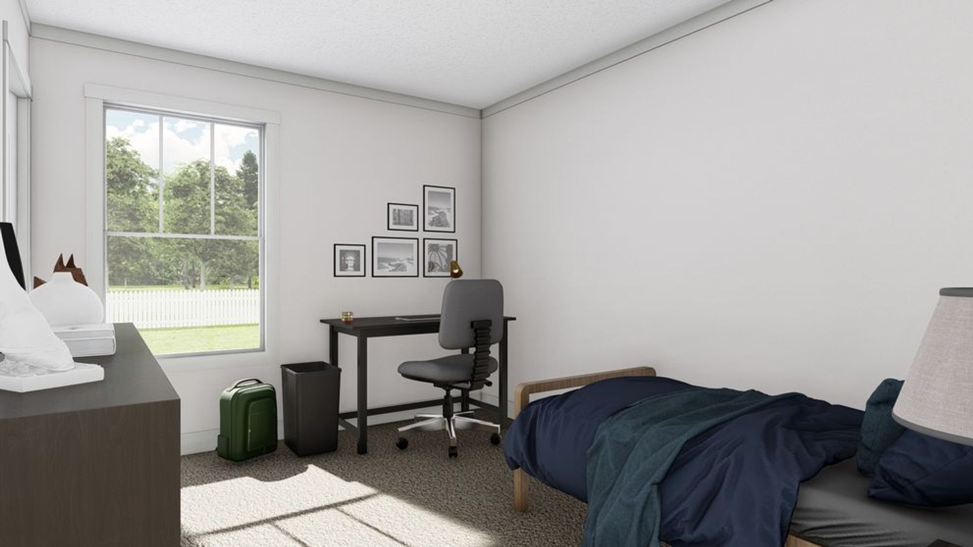 Minimalist bedroom/office combo with platform bed, dark blue bedding, black desk setup, gallery wall of framed prints, and garden view window.