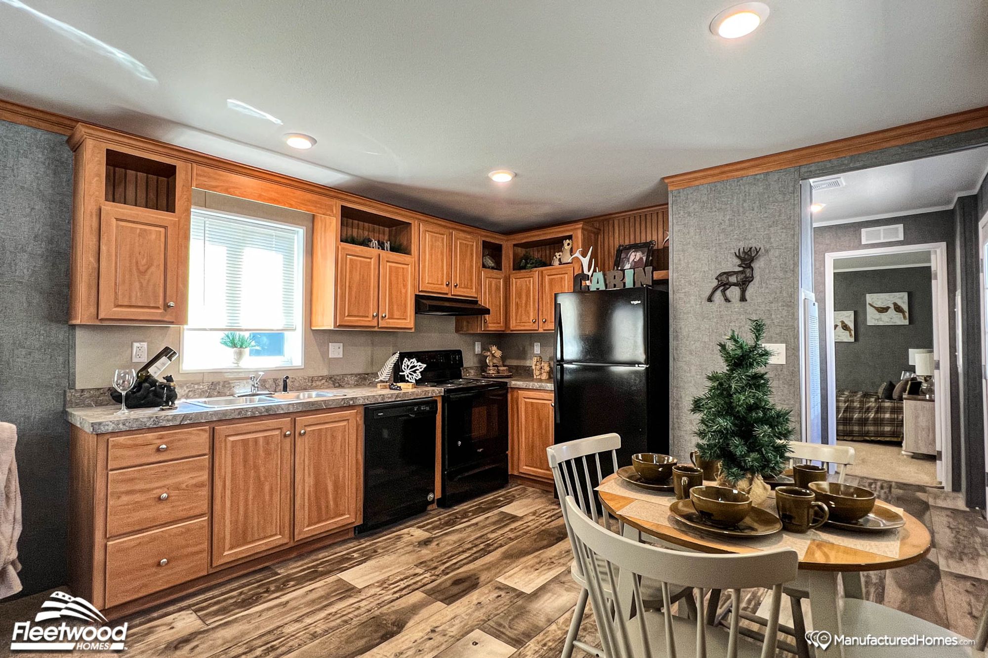 Large kitchen with a dining room, featuring medium-toned wooden cabinetry.