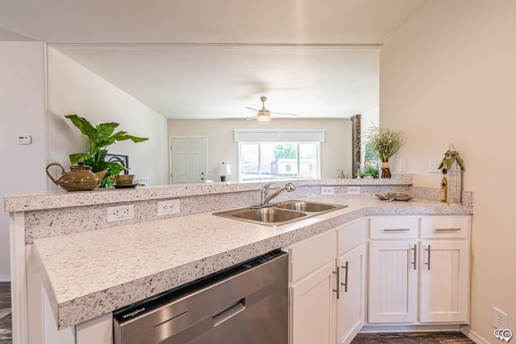 Close-up of a kitchen area with a sink and a dishwasher.