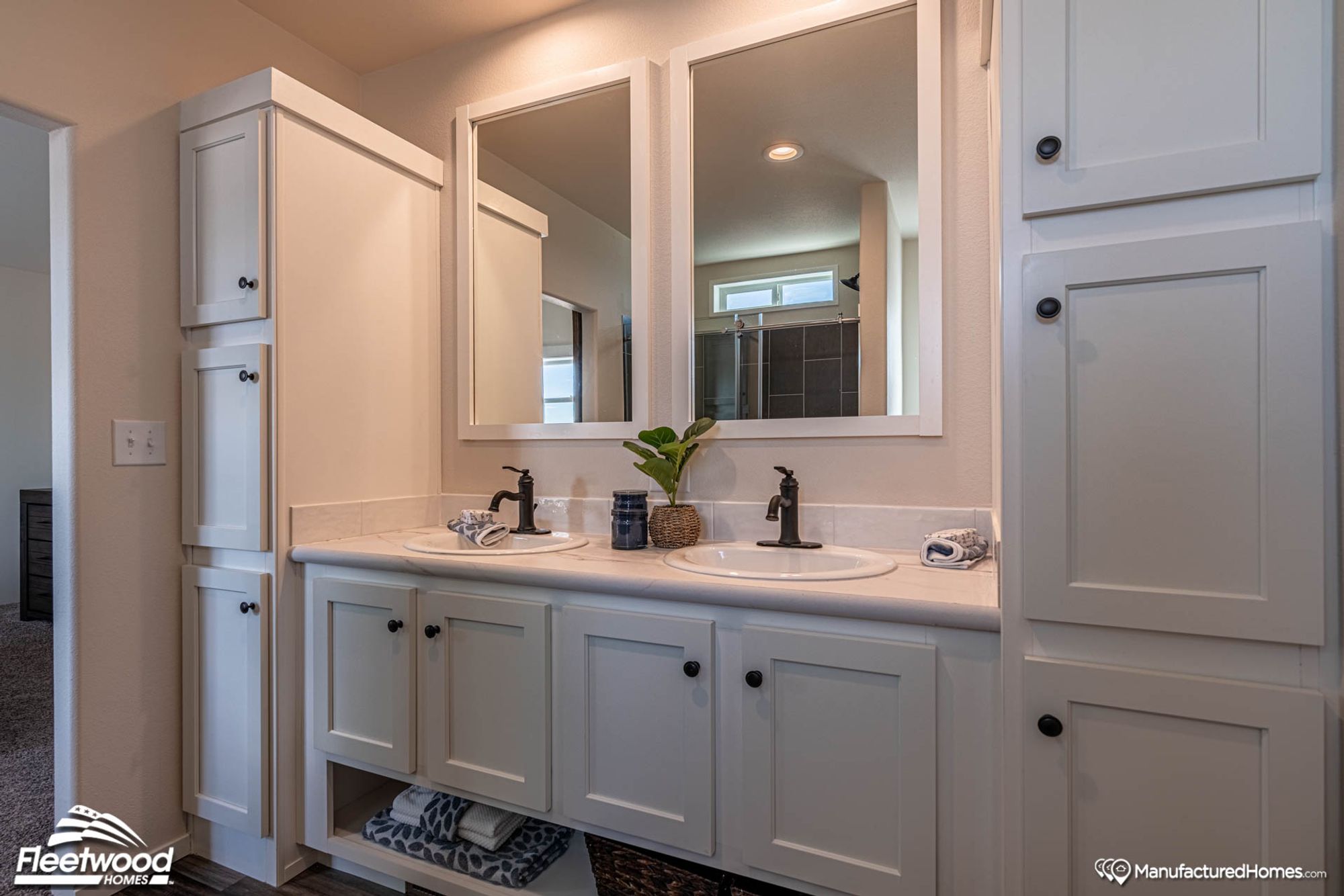 Double sink with two large end cabinets.
