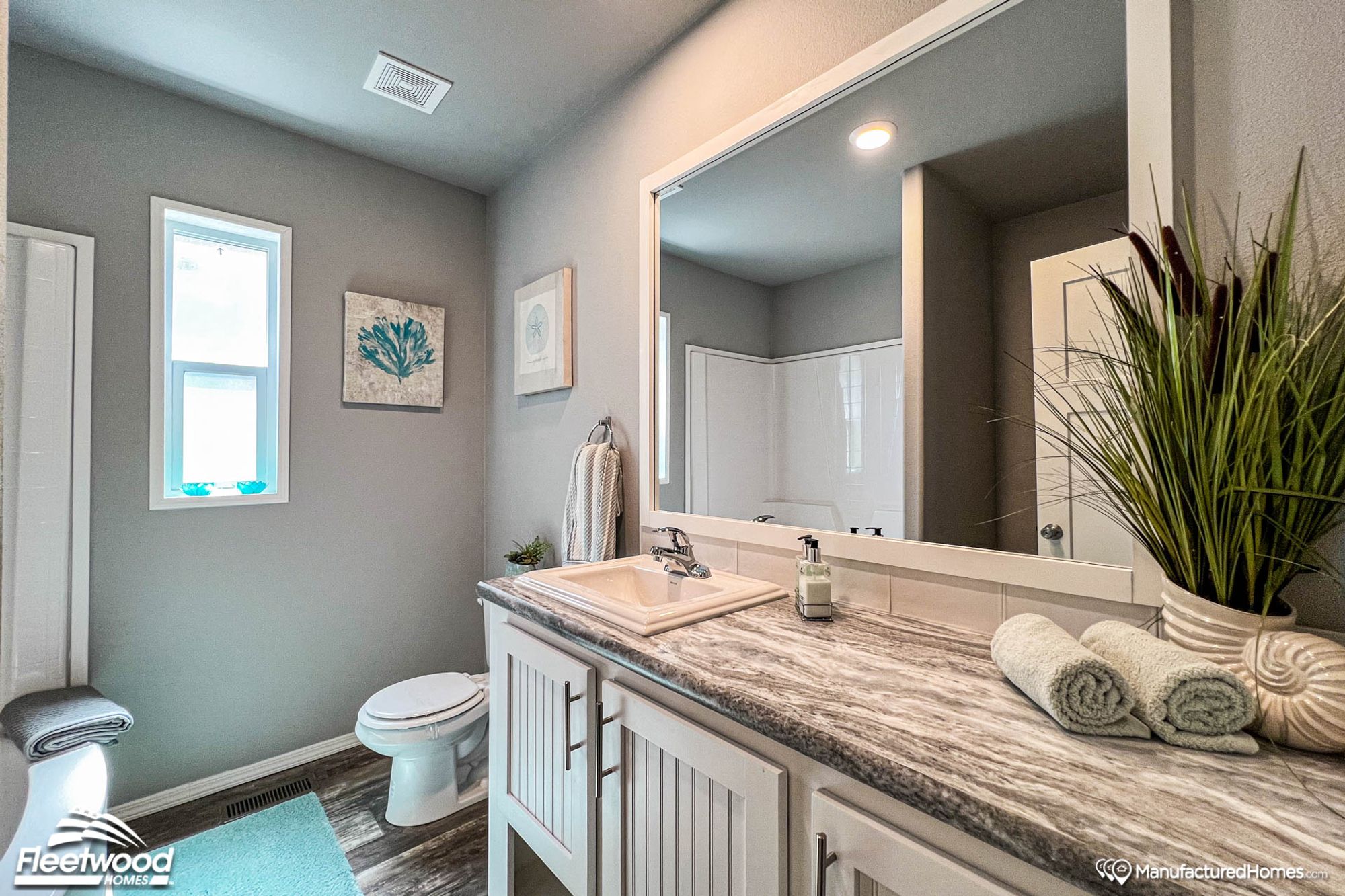 Partial view of a bathroom with a large countertop and a single sink.
