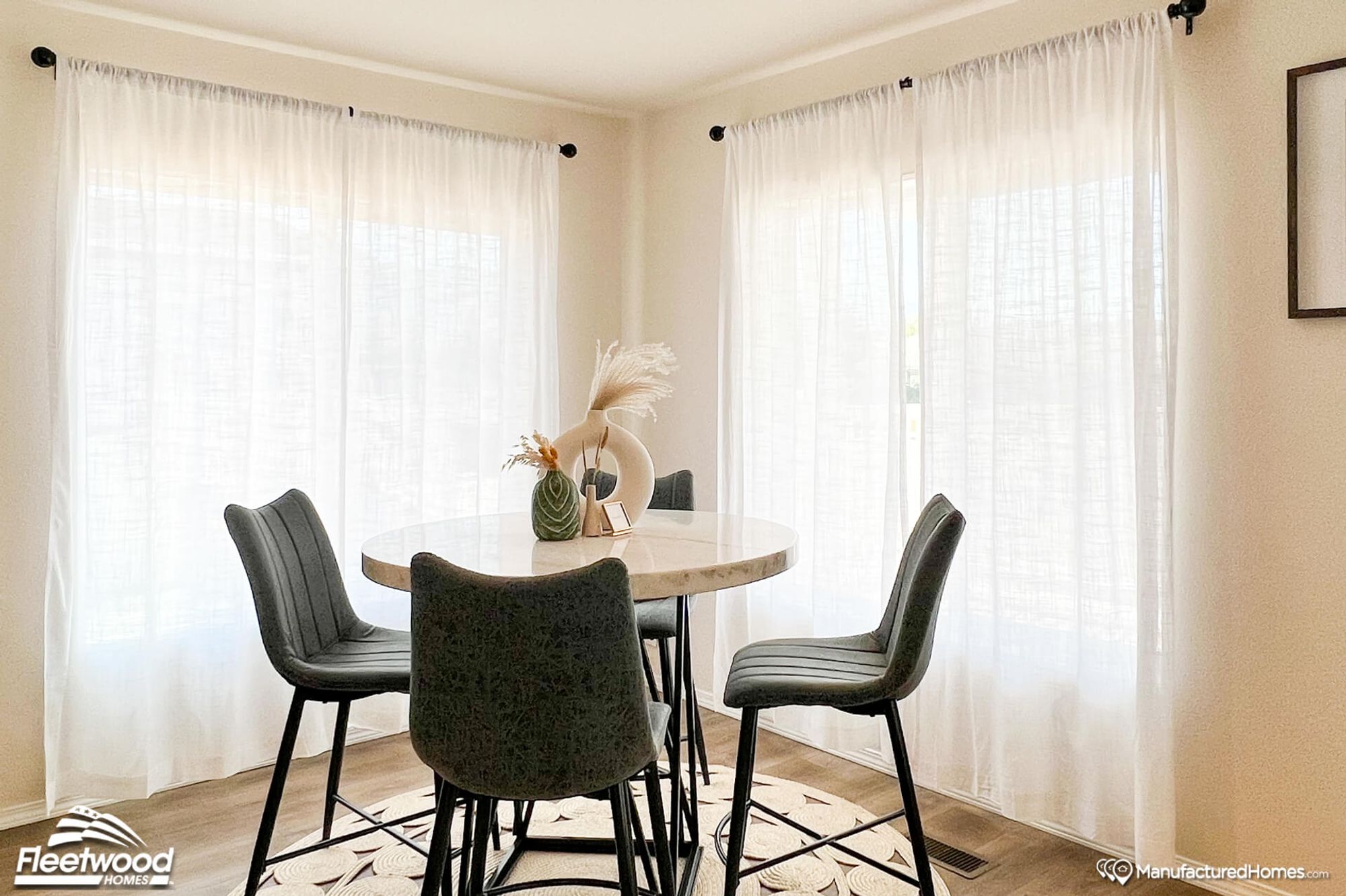Mid-sized dining room with a round table that seats 4.