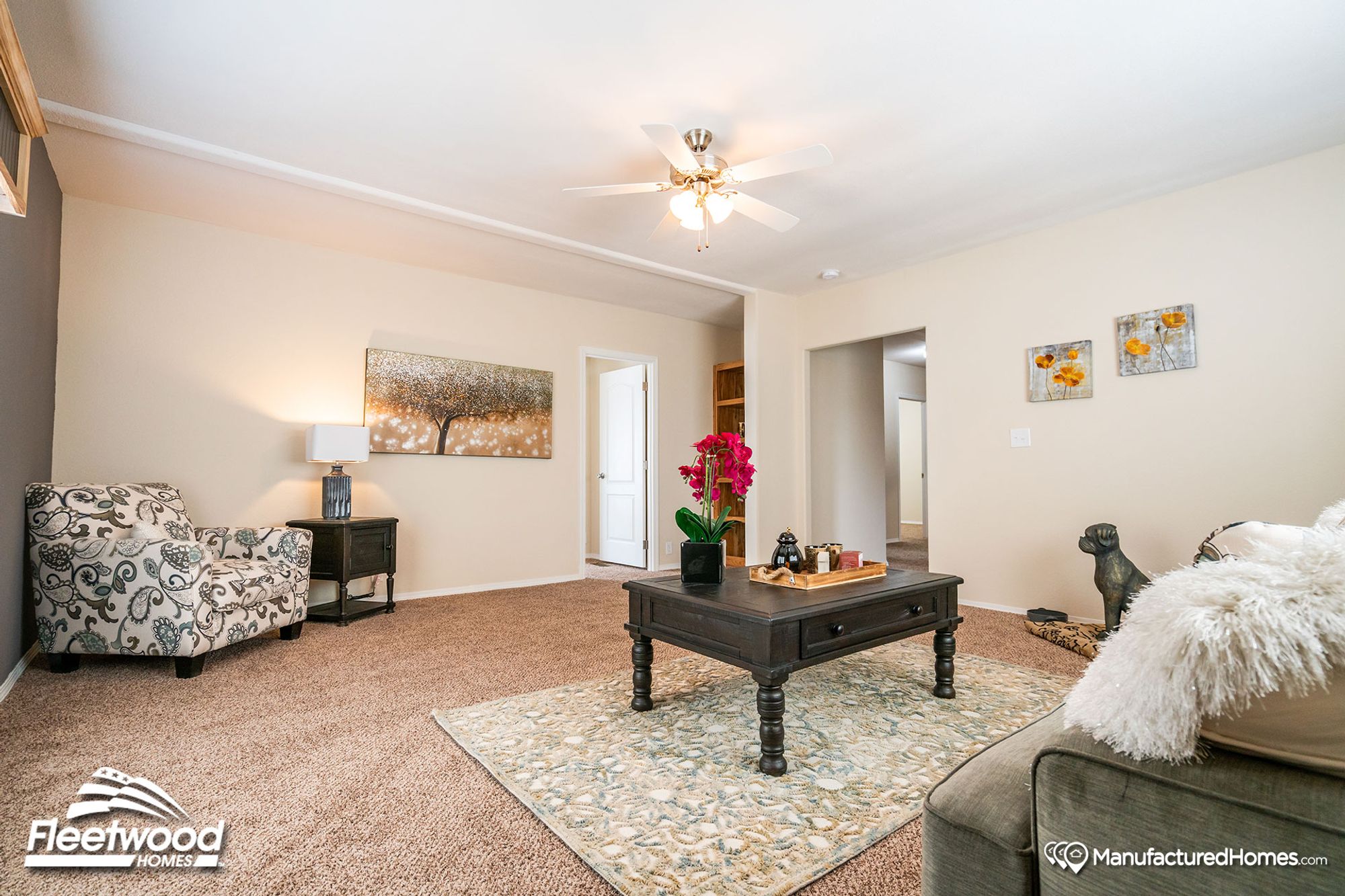 Large living room with a couch, a single chair, a coffee table, and a side table.