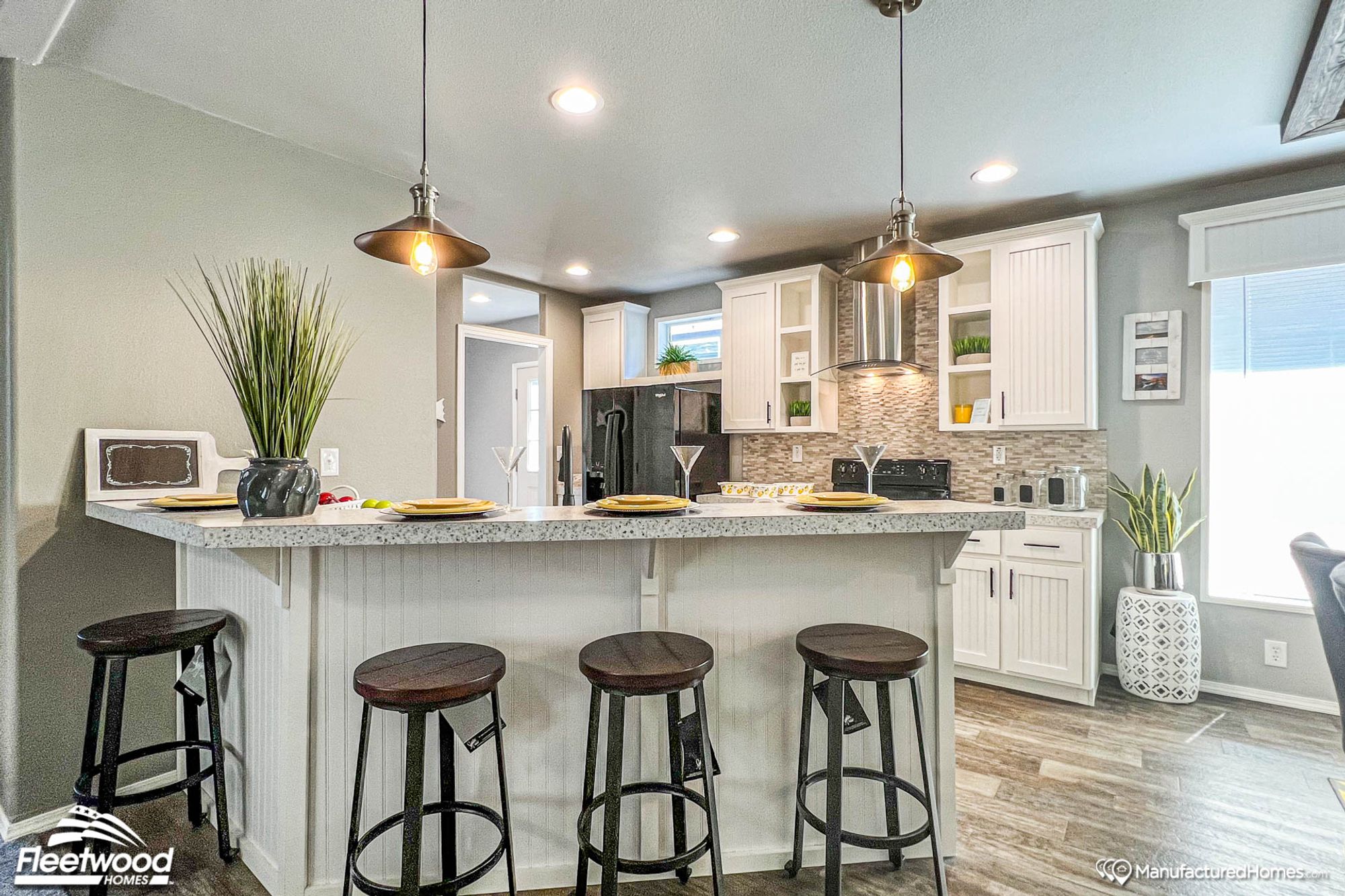 Kitchen with a raised breakfast bar attached to the main counter, with space for barstools.