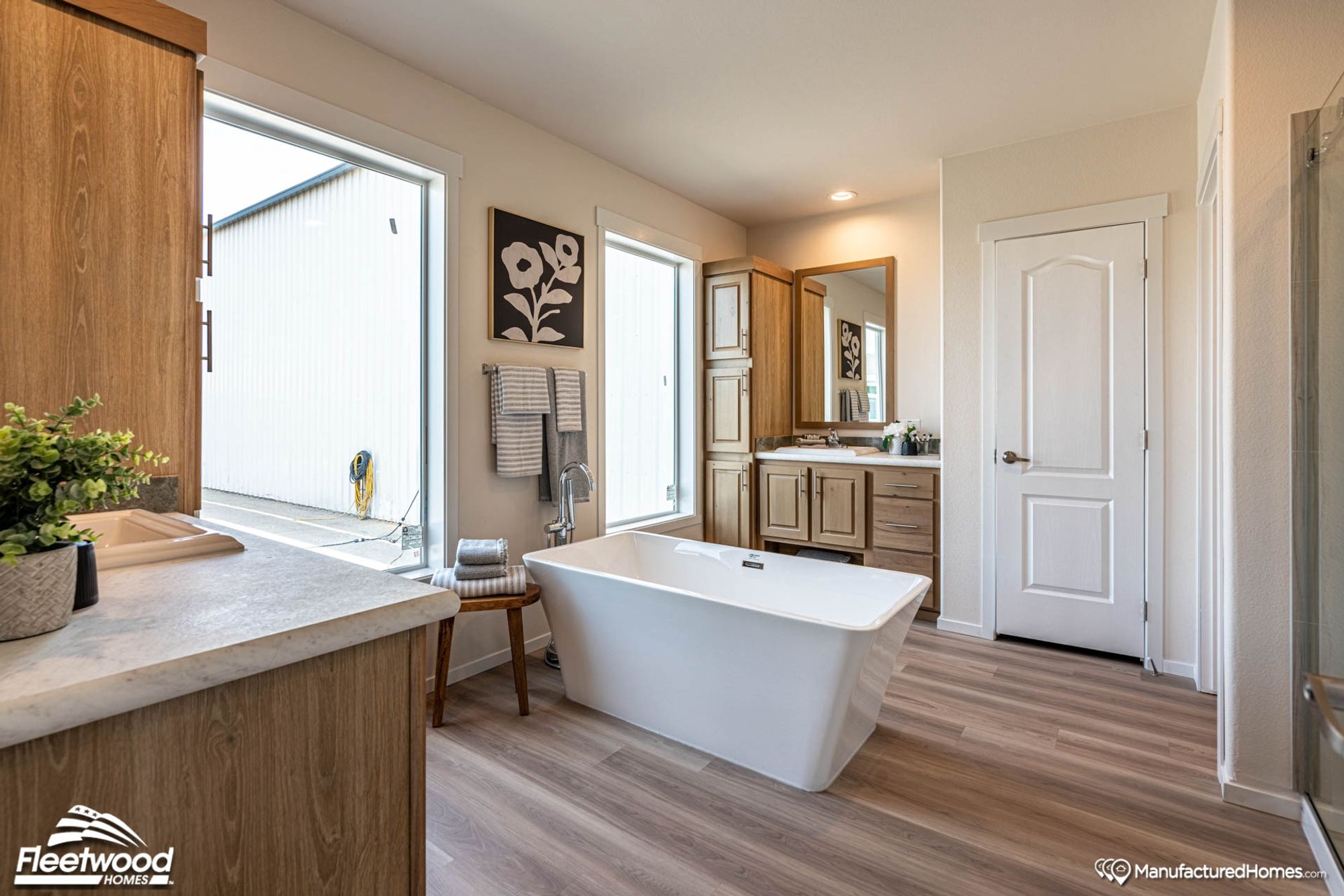 Large bathroom with a bathtub and a standing shower.