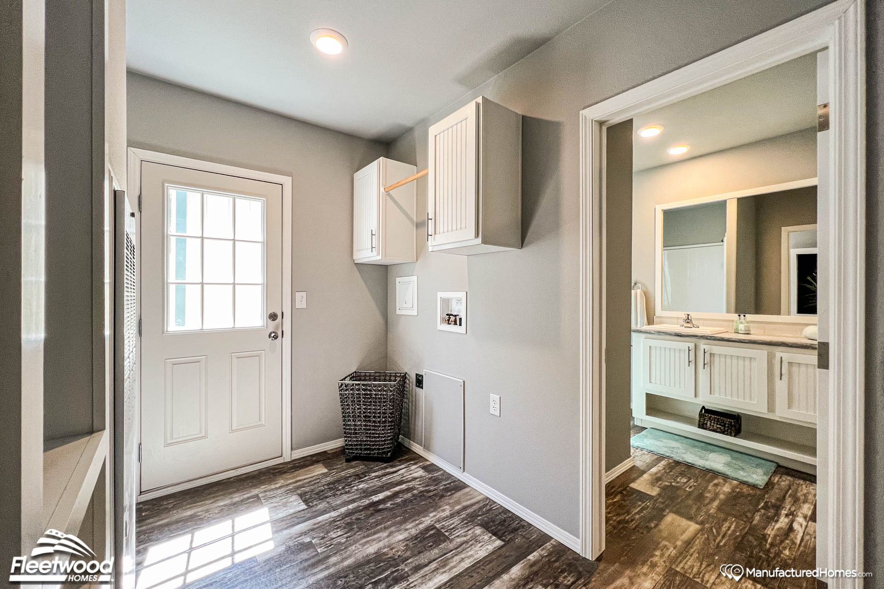 Mid-sized entryway with wooden flooring and wall storage.