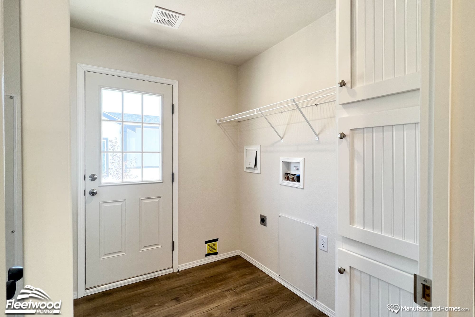 Large entryway with white wall-mounted shelves.