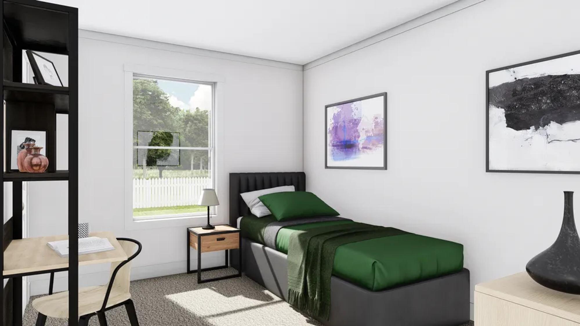 Mid-sized bedroom with a green twin bed , a desk, and a side table.