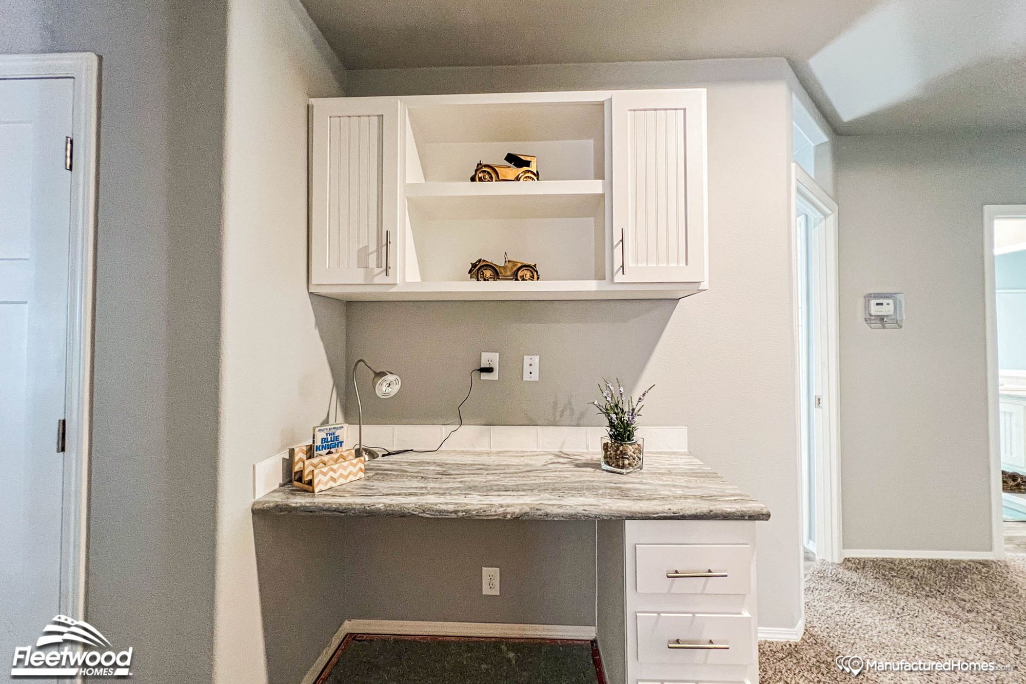 Hallway area with a built-in desk featuring a marble top.
