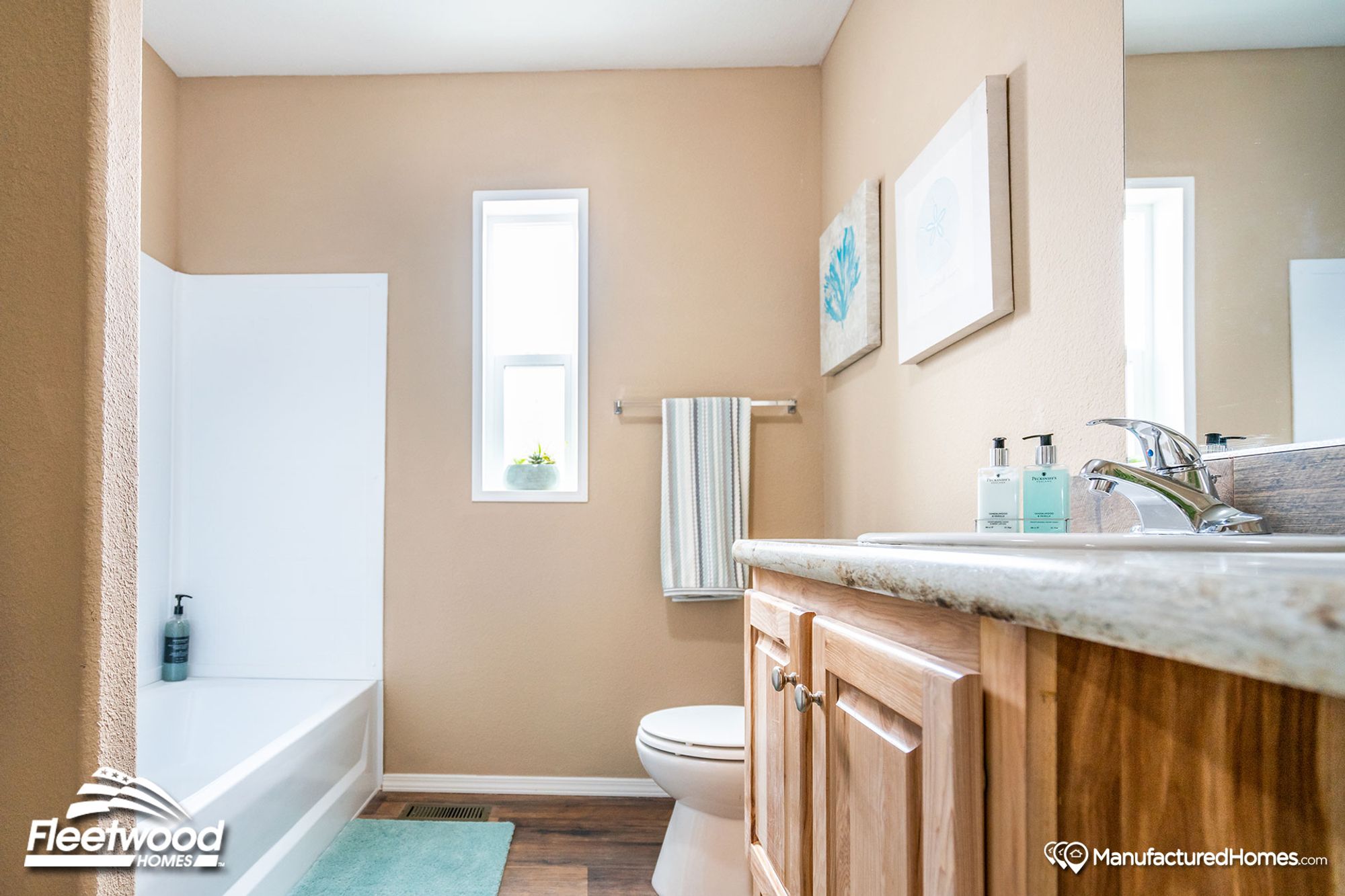 Mid-sized bathroom with a bathtub-shower combo and a single sink counter top.