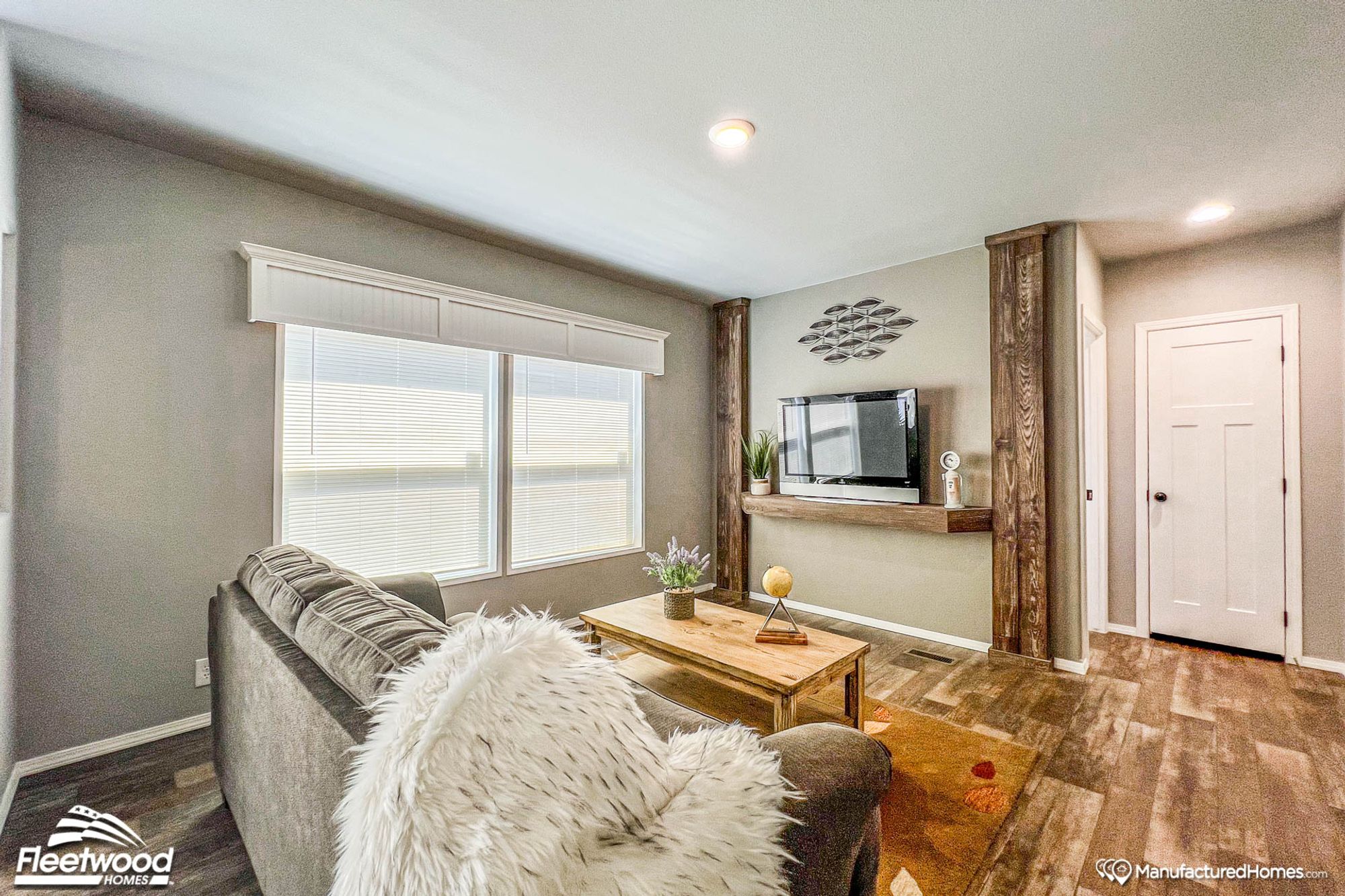 Mid-sized living room with a couch and an entertainment center.