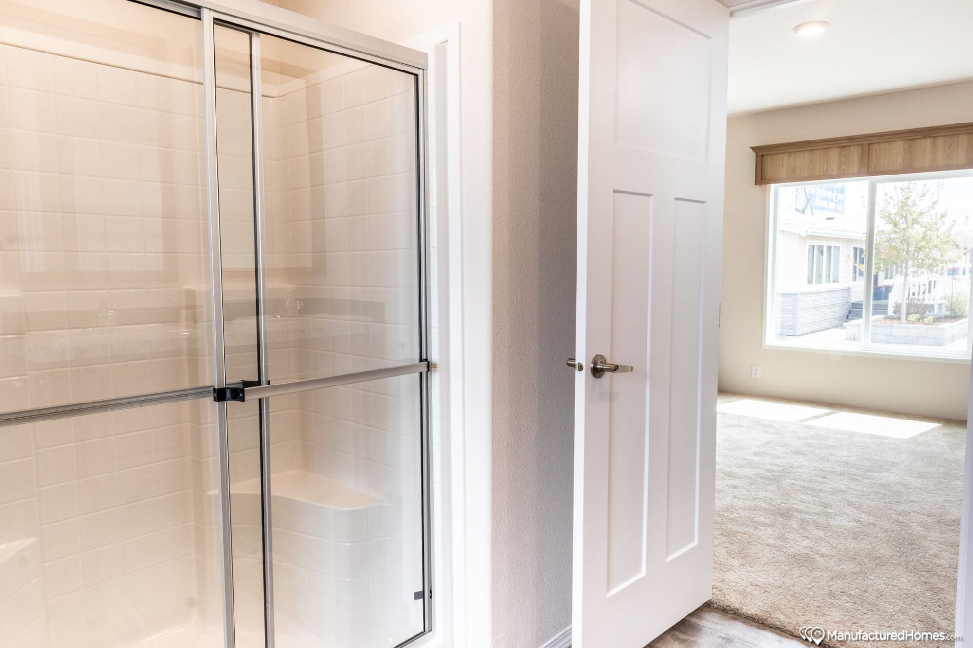 Partial view of a bathroom with a large standing shower.