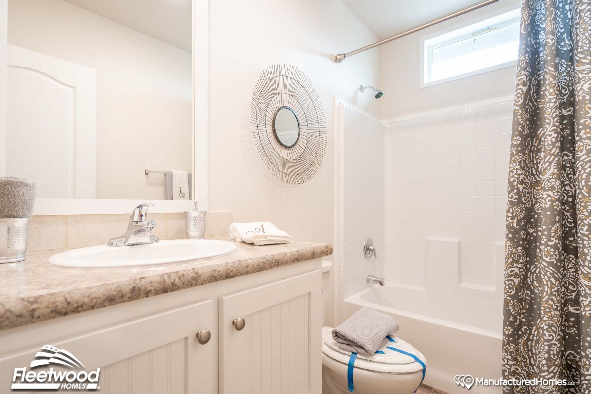 Bathroom with a single-sink countertop and a bathtub-shower combination.