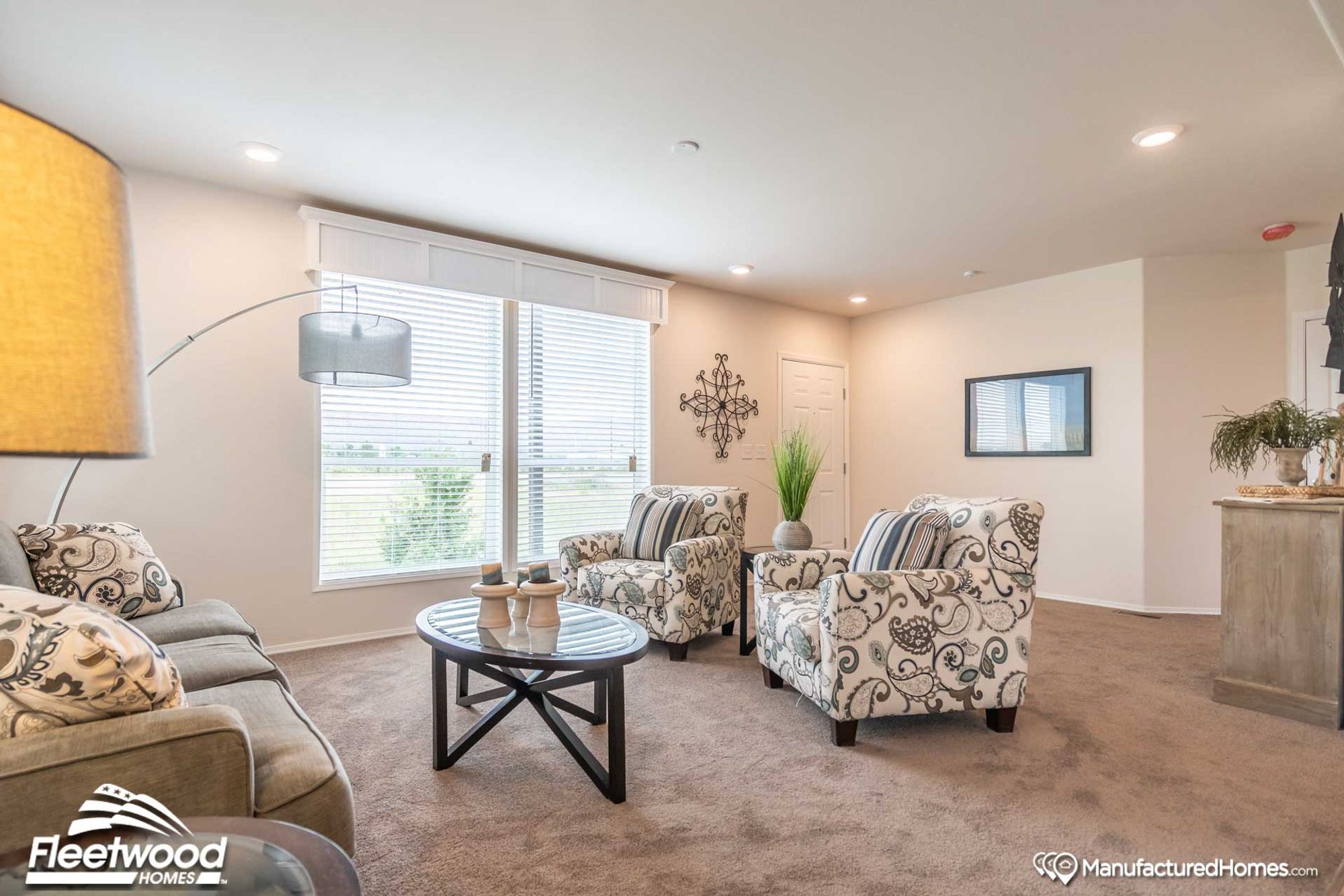 Large living room with two chairs and a couch.