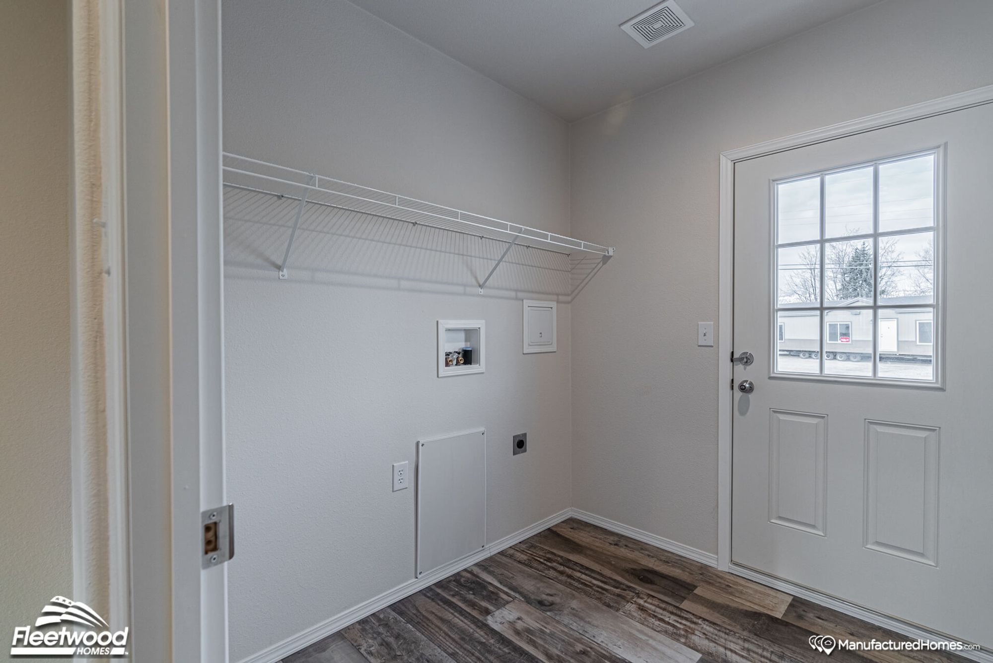 Entryway with a wall-to-wall tall shelf.