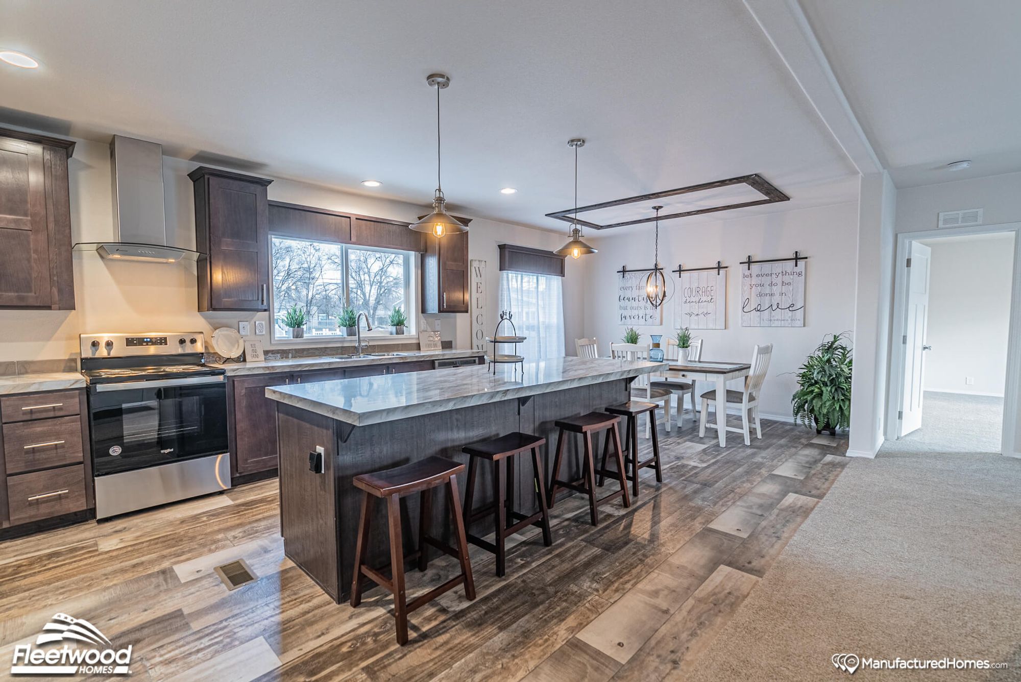 Large kitchen with a large island and dining room in the background.