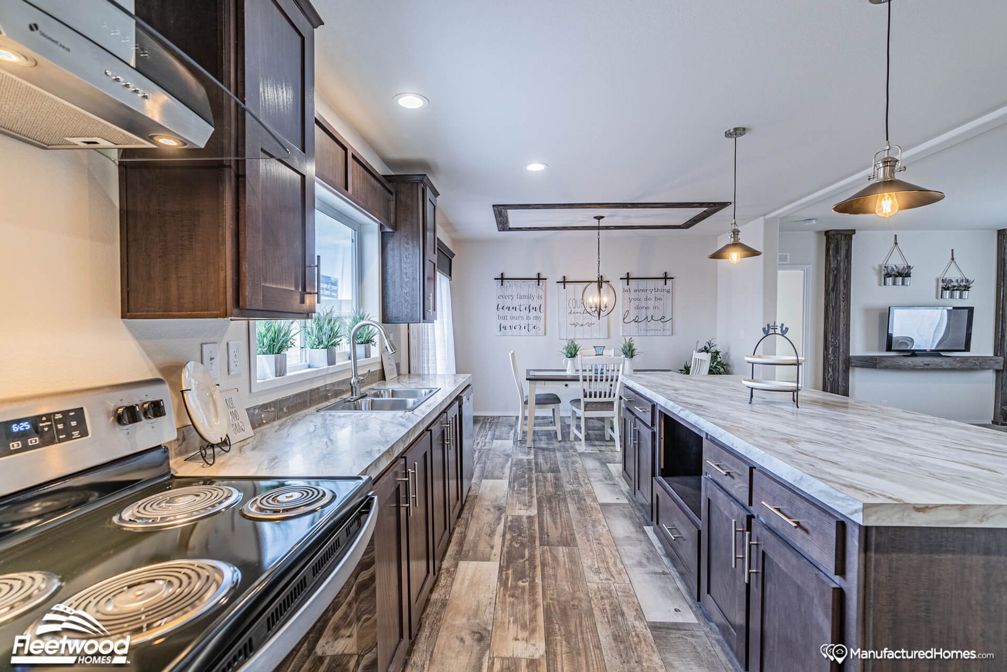Large kitchen with a large island and dining room in the background.