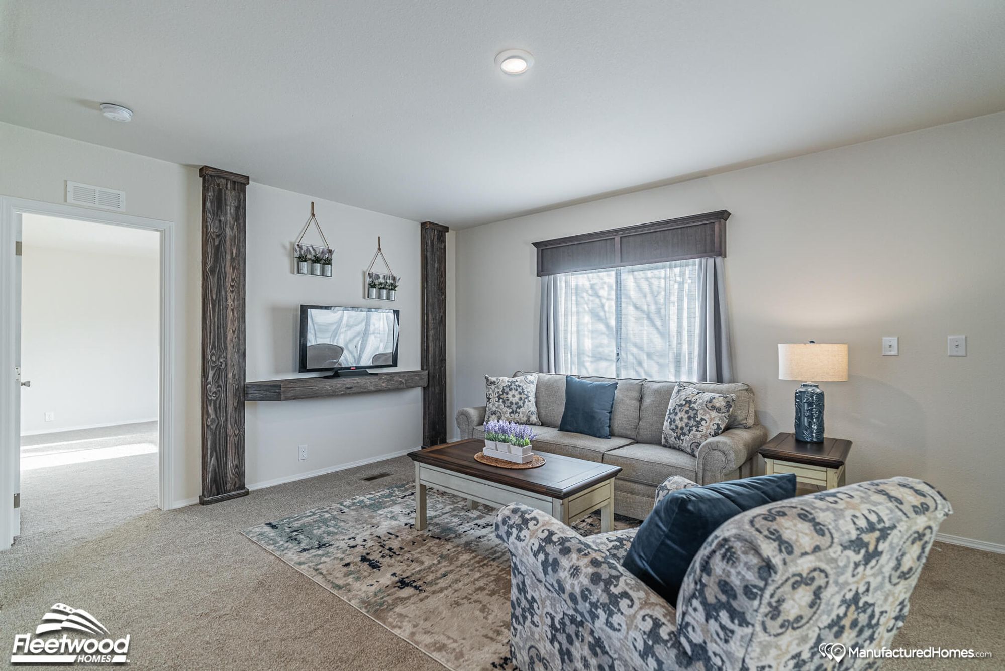 Large living room with one couch and one chair and a coffee table
