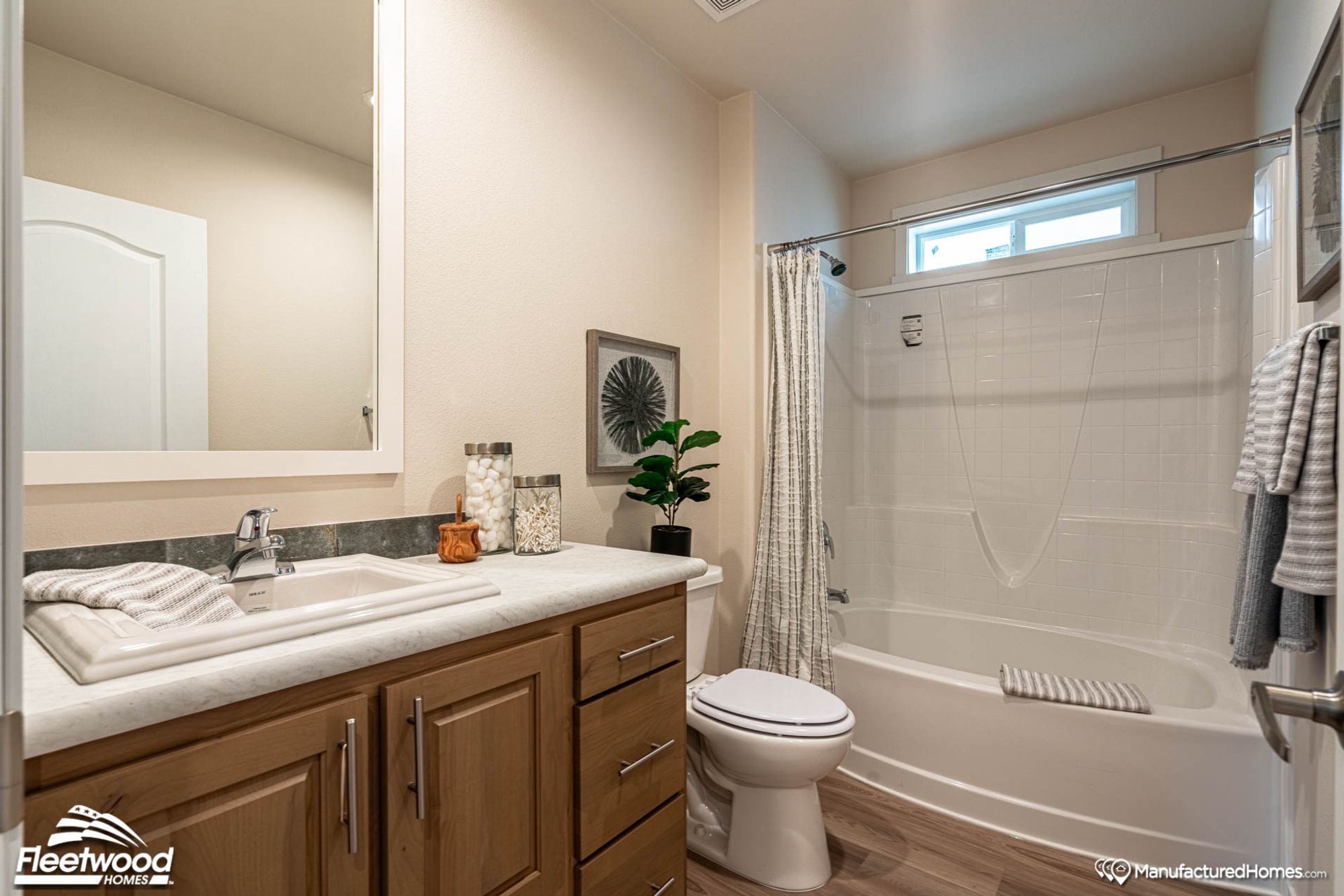 Bathroom with a single-sink countertop and a bathtub-shower combination.