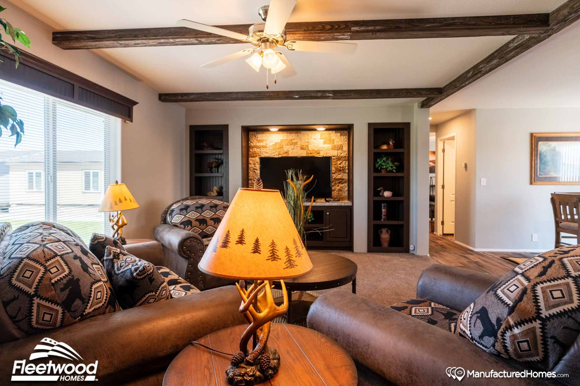 Mid-sized living room with three chairs, a coffee table, a side table, and a fire place.