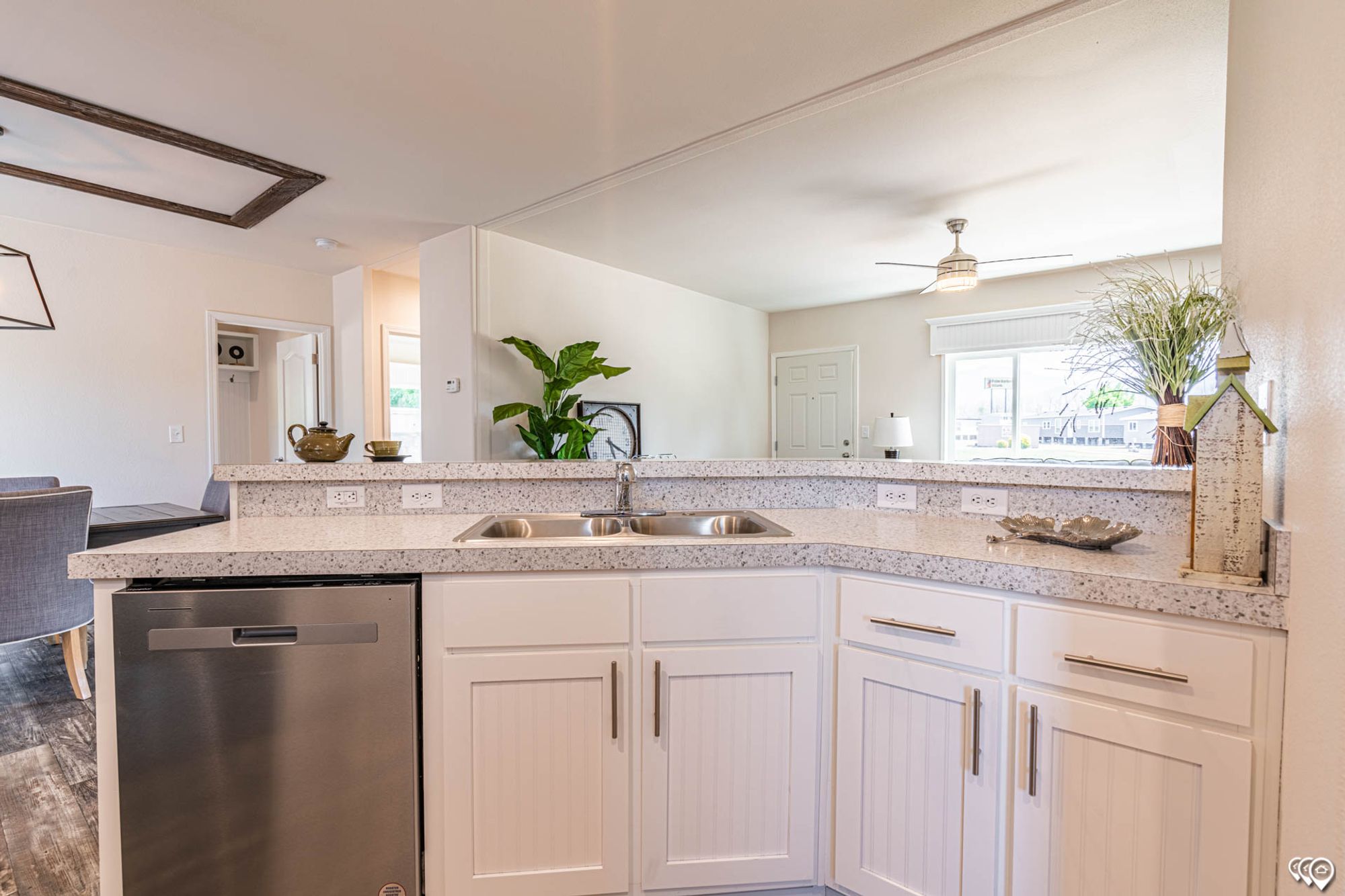 Close-up of a kitchen area with a sink and a dishwasher.