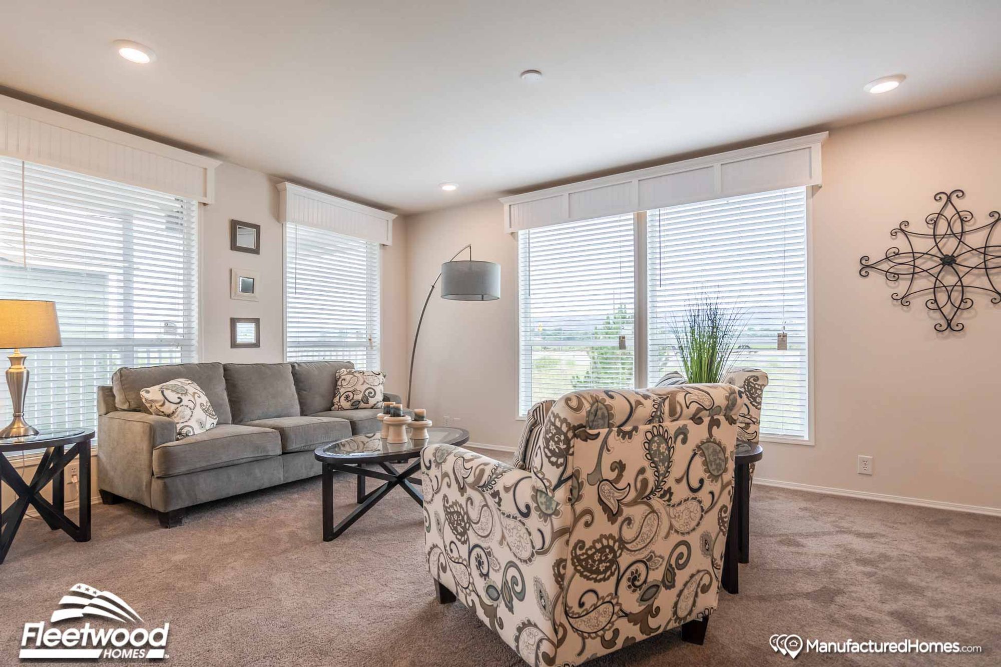 Large living room with two chairs and a couch.